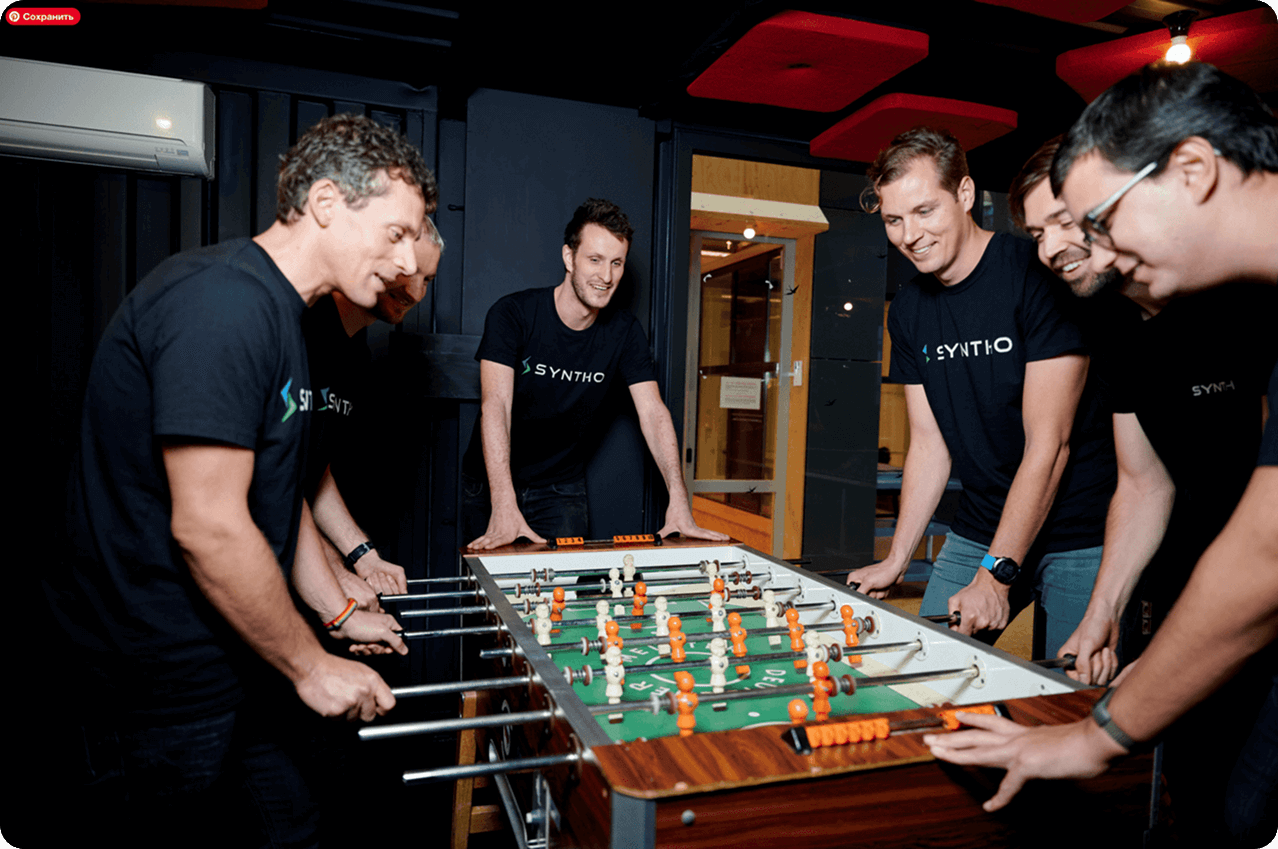 Syntho Team playing foosball with rounded corners